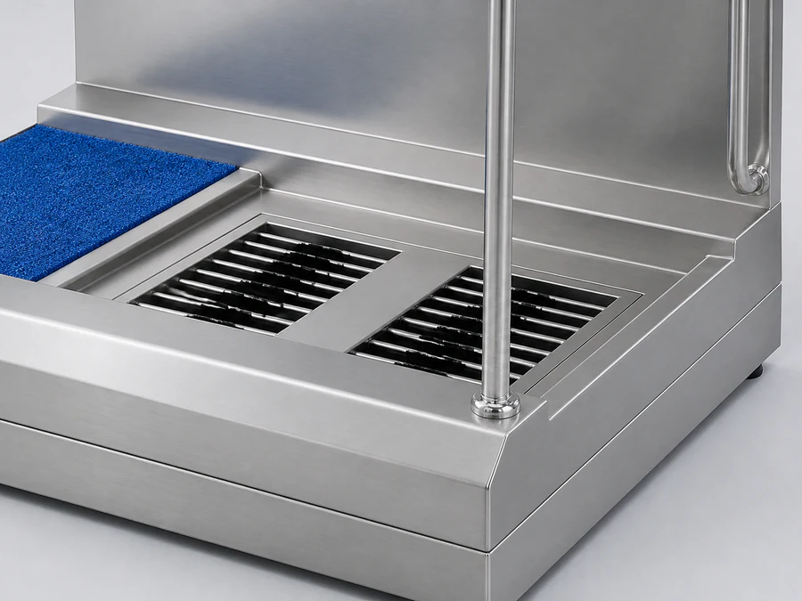 Two sole brushes and the adjacent blue mat on a hygiene station platform